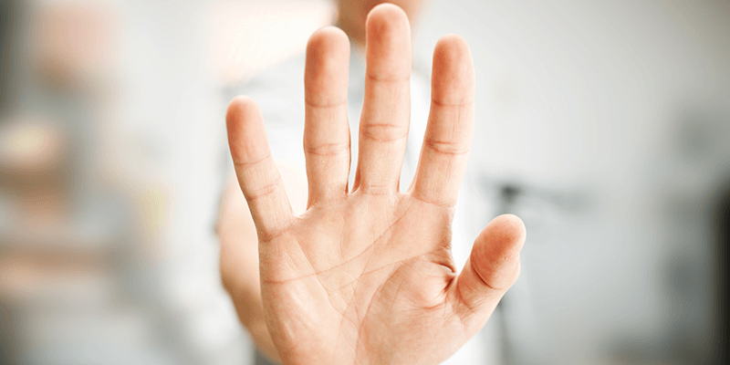 A hand being held up to indicate stop.